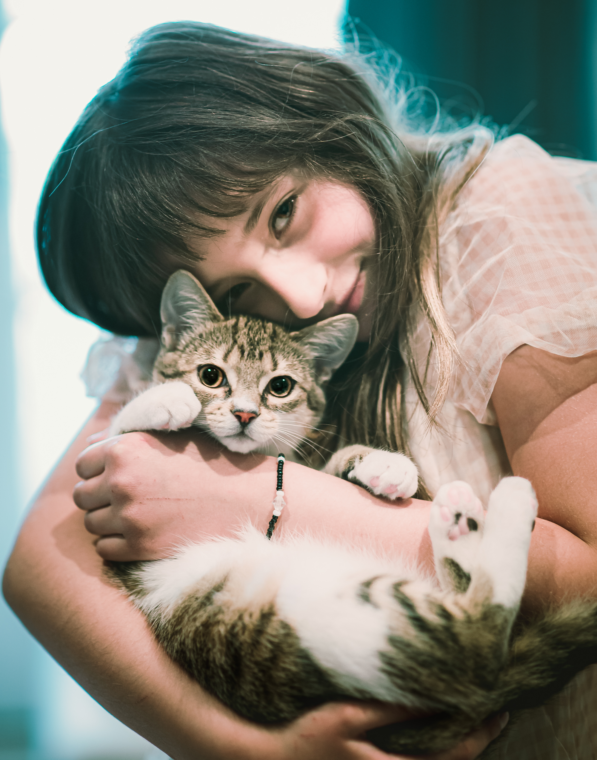 Girl holding a tabby cat