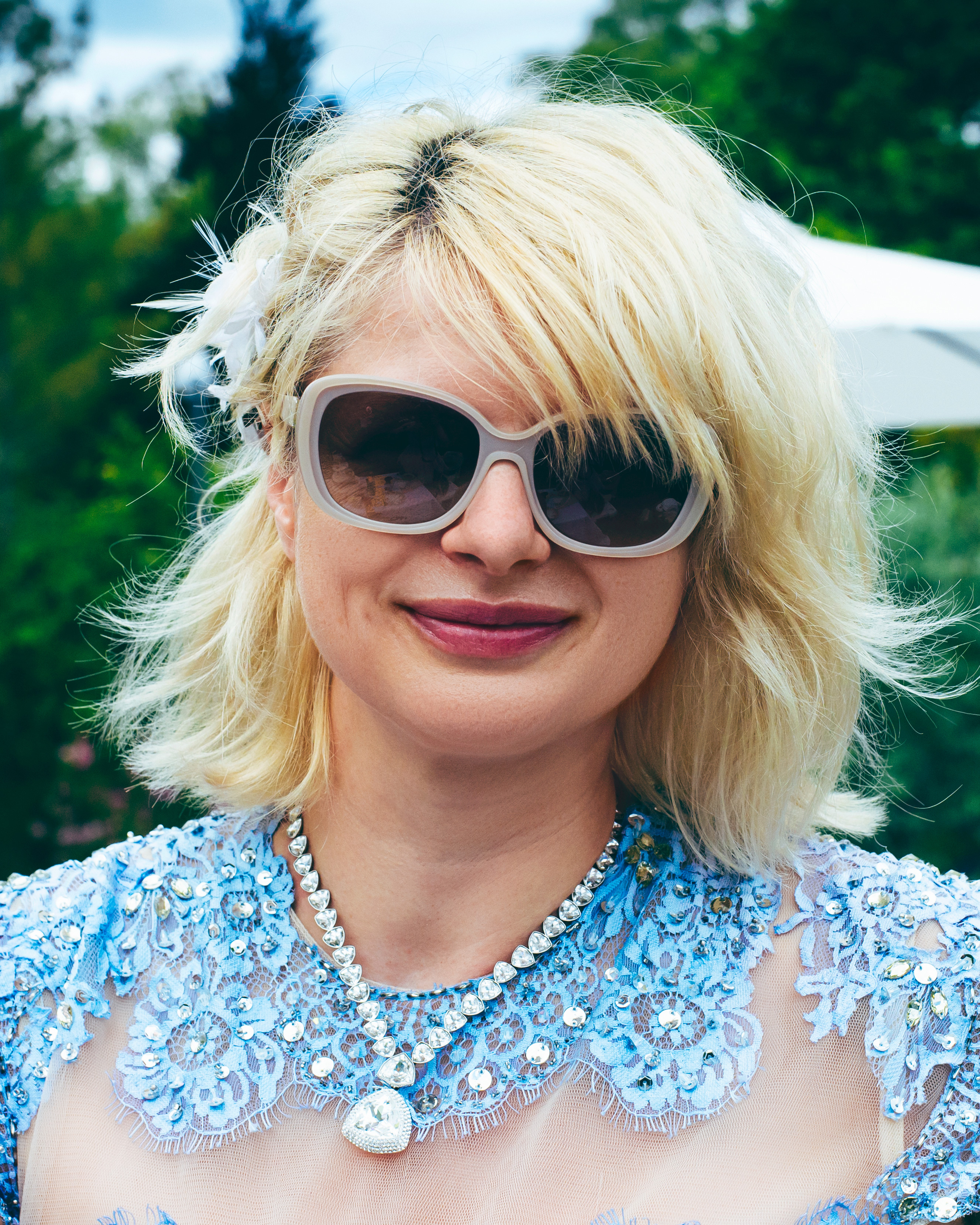 Smiling woman in a blue lace dress