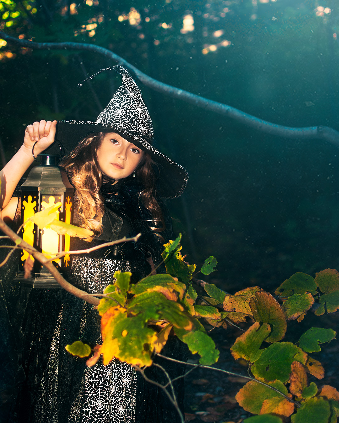 Witch girl looking ahead with a lantern