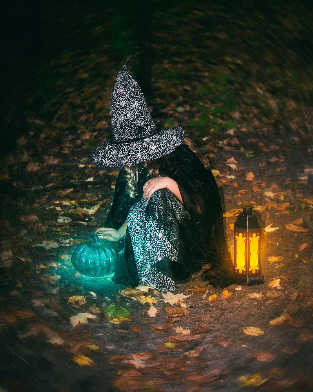 Girl with glowing pumpkin and lantern